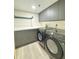 Efficient laundry room featuring front-load washer and dryer and built in cabinets at 4460 Fairways Blvd # 304, Bradenton, FL 34209