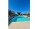 Beautiful outdoor community swimming pool with clear blue water and lounge chairs at 4460 Fairways Blvd # 304, Bradenton, FL 34209