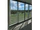 Balcony view showing lush green golf course, blue sky, and sliding glass doors at 4460 Fairways Blvd # 304, Bradenton, FL 34209
