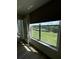 Window view showing lush greenery, a pond, and a blue sky, with light streaming in at 4460 Fairways Blvd # 304, Bradenton, FL 34209