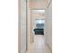 Hallway view of a bathroom featuring a bath, vanity and neutral tile at 4464 Mcintosh Lake Ave, Sarasota, FL 34233