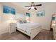 Cozy bedroom with ceiling fan, beach-themed decor, and natural light at 4464 Mcintosh Lake Ave, Sarasota, FL 34233
