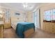Bedroom boasting tropical coral curtains, ceiling fan, and closet at 4464 Mcintosh Lake Ave, Sarasota, FL 34233