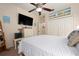 This spacious bedroom features a ceiling fan and a large television for entertainment at 4464 Mcintosh Lake Ave, Sarasota, FL 34233