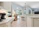 Bright kitchen with a breakfast bar, white cabinetry, and stainless steel appliances at 4464 Mcintosh Lake Ave, Sarasota, FL 34233