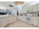 Well-lit kitchen features white cabinets, modern appliances, and granite countertops at 4464 Mcintosh Lake Ave, Sarasota, FL 34233