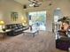 Cozy living room with plush seating, ceiling fan, and sliding glass doors that view the private pool area at 4464 Mcintosh Lake Ave, Sarasota, FL 34233