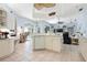 Open kitchen with an island, white appliances, and tile floor at 4464 Mcintosh Lake Ave, Sarasota, FL 34233