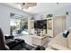 Open living room with a sliding glass door to the pool area, and built-in shelving at 4464 Mcintosh Lake Ave, Sarasota, FL 34233
