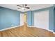 This bedroom has blue walls, vinyl flooring, a ceiling fan and access to a large closet at 4933 Rutland Gate, Sarasota, FL 34235