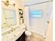 Bathroom with a large mirror, modern vanity, marble countertop, and tub-shower with tile surround at 5016 Mangrove Point Rd, Bradenton, FL 34210