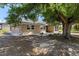 Exterior backyard view of home with patio, and a mature tree providing shade at 510 Marlin Dr, Punta Gorda, FL 33950