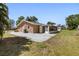 Rear view of the home showcasing the large concrete backyard patio and lawn at 510 Marlin Dr, Punta Gorda, FL 33950