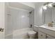 Well-lit bathroom featuring white bathtub, shower, toilet, and vanity at 510 Marlin Dr, Punta Gorda, FL 33950