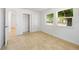 Bright bedroom with tile flooring, closet, and two windows offering natural light at 510 Marlin Dr, Punta Gorda, FL 33950