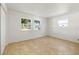 A spacious bedroom with large windows, tile floors, and white walls at 510 Marlin Dr, Punta Gorda, FL 33950