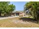 Charming single-story home featuring neutral stucco, a screened garage, and tropical landscaping at 510 Marlin Dr, Punta Gorda, FL 33950