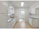 Galley kitchen features white cabinets, granite countertops, stainless sink and neutral flooring at 510 Marlin Dr, Punta Gorda, FL 33950