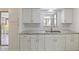 Bright kitchen featuring white cabinets, marble countertops, and stainless steel faucet at 510 Marlin Dr, Punta Gorda, FL 33950