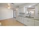 Kitchen showcasing white cabinets, a marble countertop, tile floors, and modern fixtures at 510 Marlin Dr, Punta Gorda, FL 33950