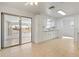 Bright kitchen featuring white cabinetry, neutral tile, and sliding glass door to screened in area at 510 Marlin Dr, Punta Gorda, FL 33950