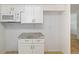 Kitchenette displaying white cabinets and appliances, including a countertop microwave at 510 Marlin Dr, Punta Gorda, FL 33950