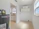 Functional laundry room with overhead cabinets and a view into the adjacent kitchen at 510 Marlin Dr, Punta Gorda, FL 33950