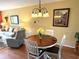 Cozy dining area adjacent to the living room features a round table and seating for four at 515 30Th W Ave # H303, Bradenton, FL 34205