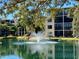 Serene view of pond with fountain and lush greenery, creating a relaxing atmosphere at 515 30Th W Ave # H303, Bradenton, FL 34205