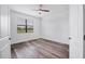 This bedroom offers wood-look floors, a ceiling fan, and natural light at 5311 White Sand Cv, Bradenton, FL 34211