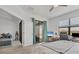 Bright bedroom featuring a ceiling fan, desk, sitting area, and sliding glass doors with an outdoor view at 5311 White Sand Cv, Bradenton, FL 34211