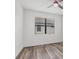 A bright bedroom with wood-look floors, a ceiling fan, and a window with blinds at 5311 White Sand Cv, Bradenton, FL 34211