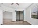 This bedroom boasts wood-look floors, a ceiling fan, and a sliding glass door at 5311 White Sand Cv, Bradenton, FL 34211