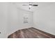 Simple bedroom design with hardwood floors, a ceiling fan, and a bright window at 5311 White Sand Cv, Bradenton, FL 34211