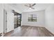 Wood-look floors, a sliding glass door, and a window with blinds enhance this bright bedroom at 5311 White Sand Cv, Bradenton, FL 34211