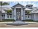 Inviting clubhouse entrance with gray accents, modern doors, and professional landscaping at 5311 White Sand Cv, Bradenton, FL 34211