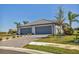 A well-maintained home boasts an attached two-car garage, lush landscaping, and a charming paver driveway at 5311 White Sand Cv, Bradenton, FL 34211
