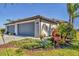 Charming single-story home showcasing a well-manicured lawn, beautiful landscaping, and a spacious two-car garage at 5311 White Sand Cv, Bradenton, FL 34211