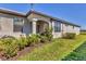 Well-maintained home featuring manicured landscaping, a covered entry, and a beautifully maintained lawn at 5311 White Sand Cv, Bradenton, FL 34211