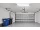 A clean, well-lit two car garage with gray epoxy floor and automatic door at 5311 White Sand Cv, Bradenton, FL 34211