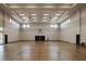 Spacious gymnasium with polished wood floors, basketball hoops, and bright natural light at 5311 White Sand Cv, Bradenton, FL 34211