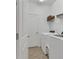 Practical laundry room with tile flooring and updated washer and dryer at 5311 White Sand Cv, Bradenton, FL 34211