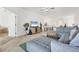 Bright living room with a large sectional sofa, ceiling fan, and open floor plan at 5311 White Sand Cv, Bradenton, FL 34211