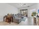 Bright living room features tile floors, ceiling fan and sliding glass doors at 5311 White Sand Cv, Bradenton, FL 34211