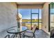 Relaxing screened-in patio features a table and seating with beautiful views of the backyard and pond at 5311 White Sand Cv, Bradenton, FL 34211