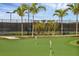 Well-manicured putting green with flags, offering a fun recreational activity in the community at 5311 White Sand Cv, Bradenton, FL 34211