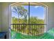 Relaxing screened balcony view with tropical foliage and green hammock for enjoying the beautiful outdoors at 5401 Bentgrass Dr # 1-302, Sarasota, FL 34235