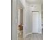 Entry to bathroom with a commode and storage box at 5401 Bentgrass Dr # 1-302, Sarasota, FL 34235