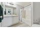 Bathroom with a tub and a vanity with a large mirror at 5401 Bentgrass Dr # 1-302, Sarasota, FL 34235