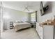 Bright bedroom with large window, ceiling fan, and light gray walls and floors at 5401 Bentgrass Dr # 1-302, Sarasota, FL 34235